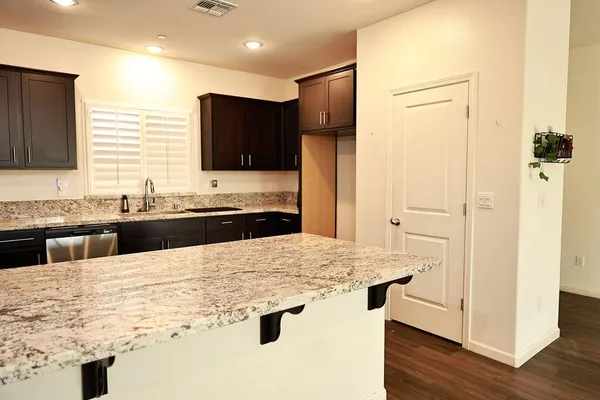 a view of a kitchen with a sink a refrigerator and a microwave