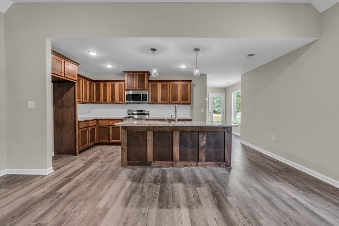101 Walnut Ridge Ripley, TN 38063 - Photo 12 of 24 a kitchen with stainless steel appliances granite countertop a stove and a sink