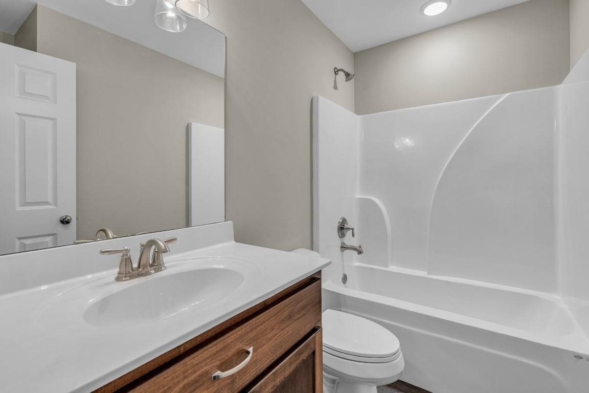 101 Walnut Ridge Ripley, TN 38063 - Photo 16 of 24 a bathroom with a sink a toilet and a large mirror