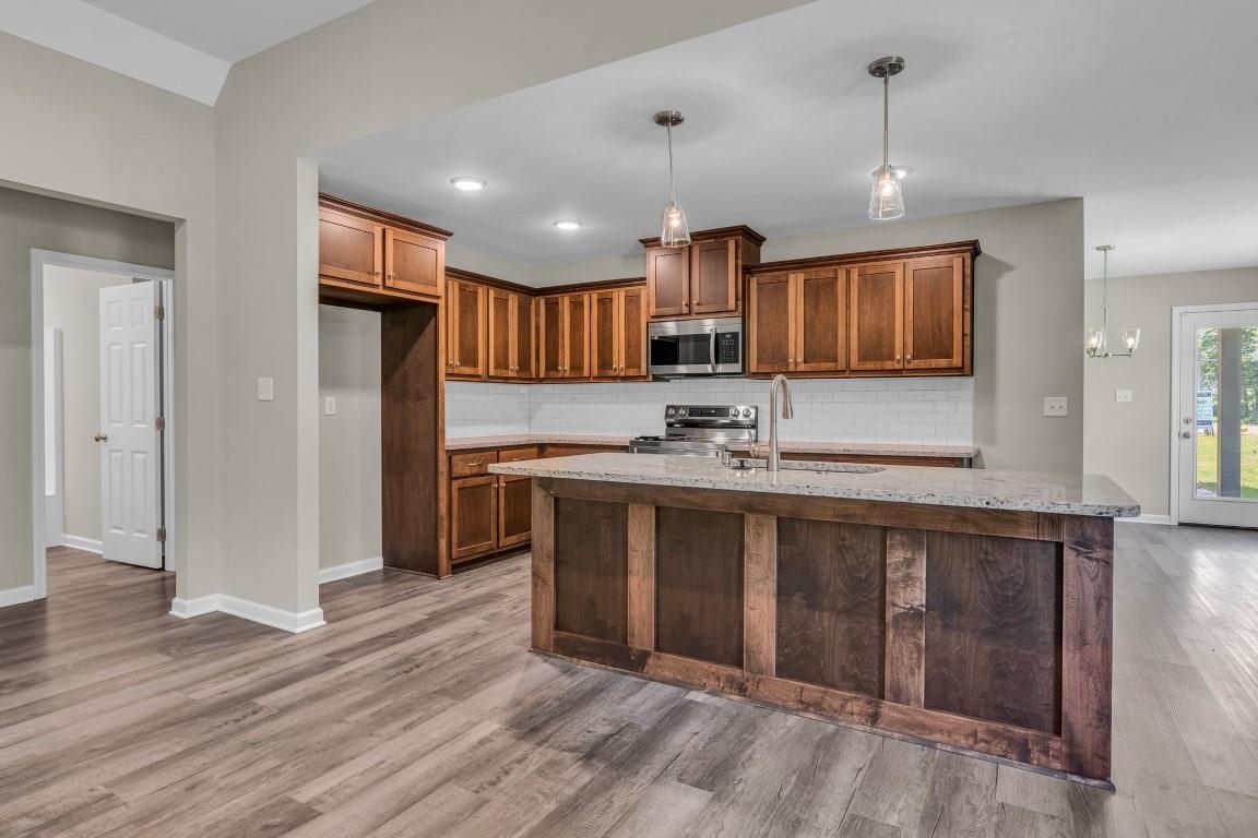 101 Walnut Ridge Ripley, TN 38063 - Photo 22 of 24 a view of kitchen with stainless steel appliances granite countertop a sink and a refrigerator