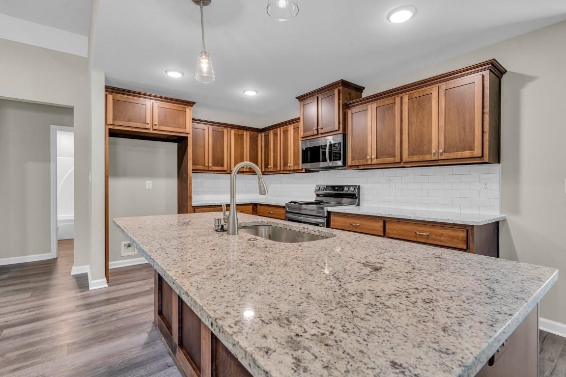 101 Walnut Ridge Ripley, TN 38063 - Photo 24 of 24 a kitchen with stainless steel appliances granite countertop a sink stove and refrigerator