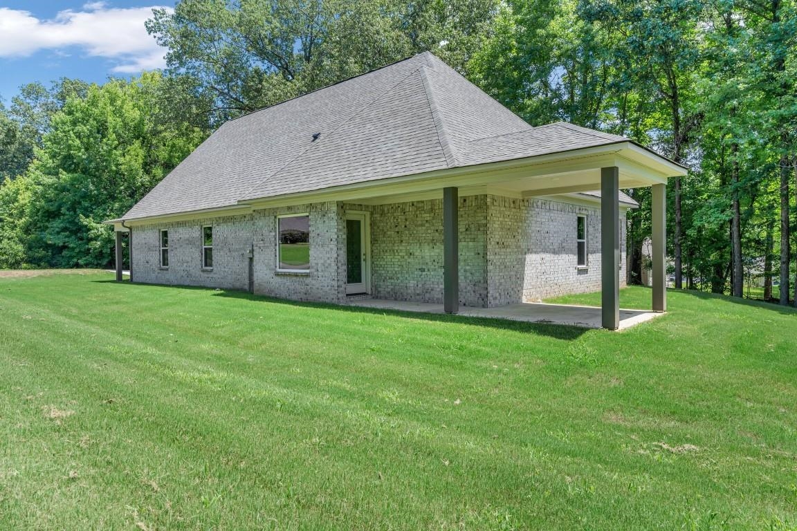 101 Walnut Ridge Ripley, TN 38063 - Photo 3 of 24 a view of a house with backyard