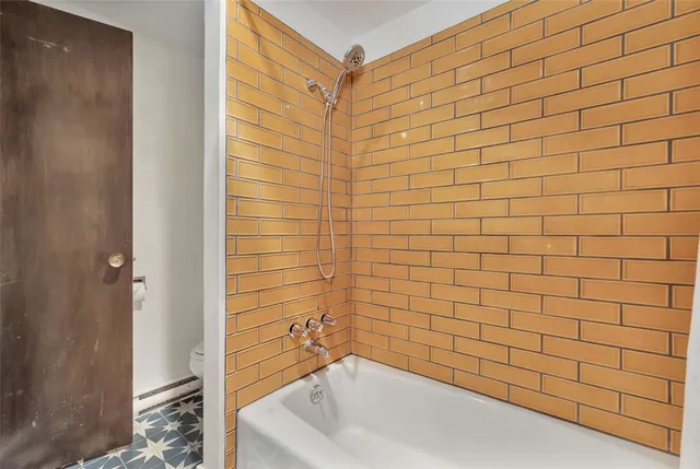 a bathroom with a bathtub and shower