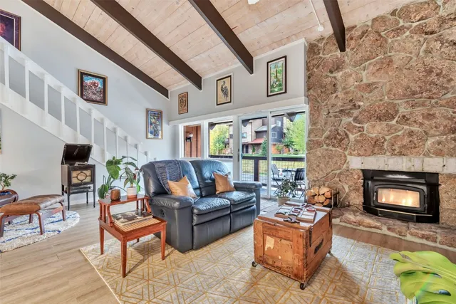 a living room with furniture fireplace and rug