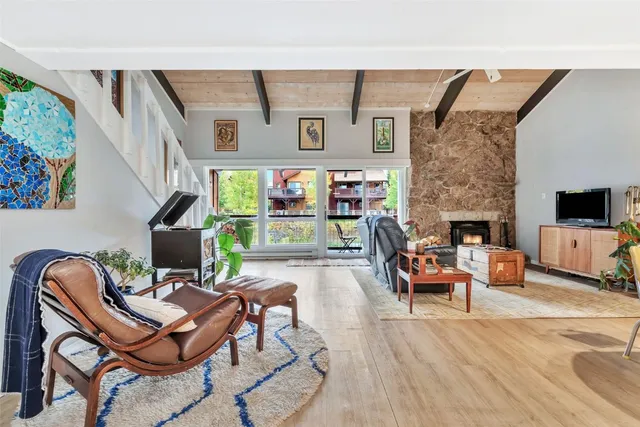 a living room with furniture a fireplace and a flat screen tv