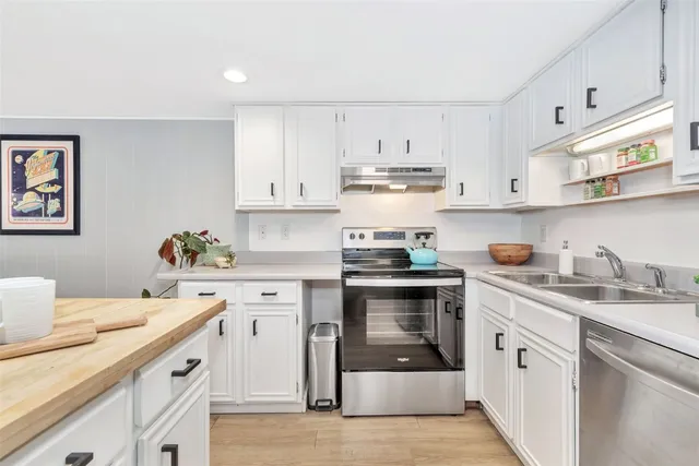 a kitchen with a sink stove and cabinets