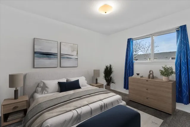 a bed room with a bed and a window