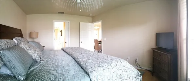 a bedroom with a bed and a dresser