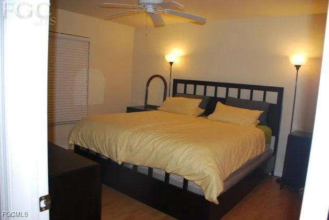 a large bed sitting in a bedroom next to a lamp