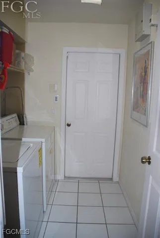 a utility room with cabinets washer and dryer