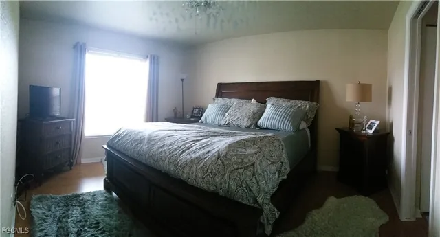 a bed sitting in a bedroom next to a window