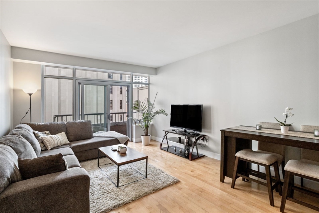 10 Bowdoin Street, Unit 514 Boston, MA 02114 - Photo 1 of 11 a living room with furniture and a flat screen tv