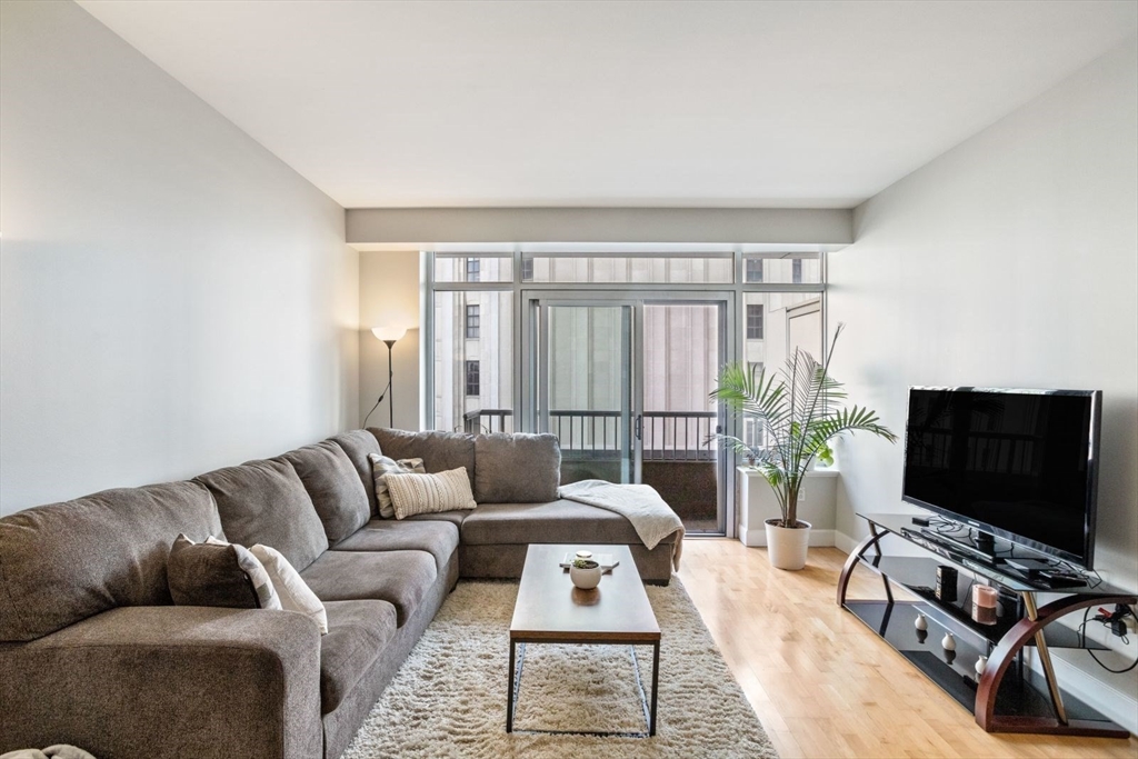 10 Bowdoin Street, Unit 514 Boston, MA 02114 - Photo 2 of 11 a living room with furniture and a flat screen tv