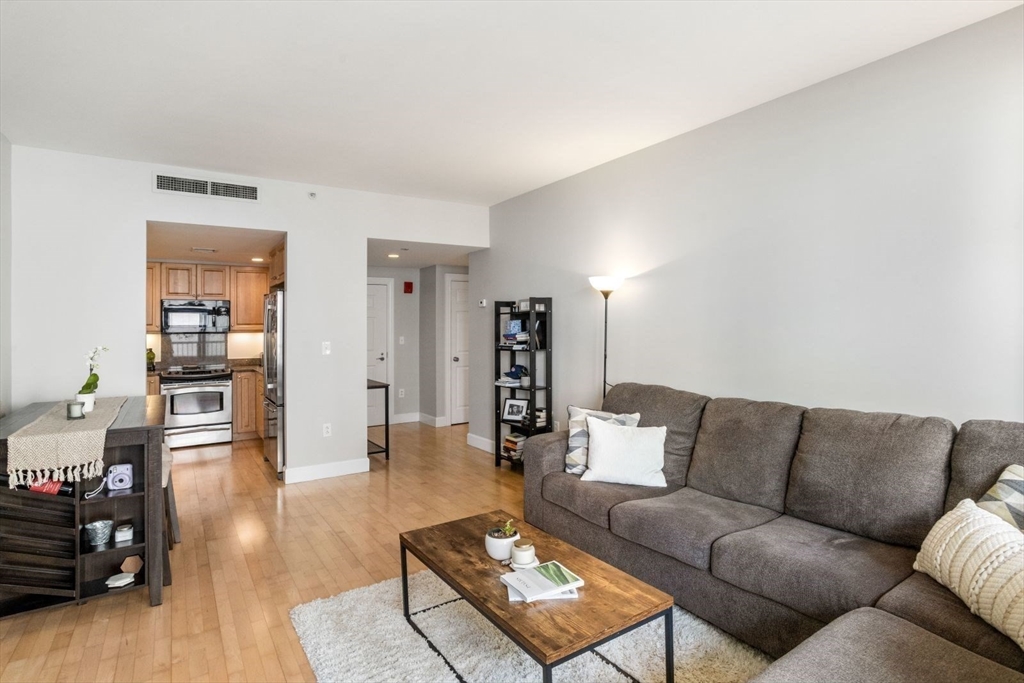 10 Bowdoin Street, Unit 514 Boston, MA 02114 - Photo 3 of 11 a living room with furniture and wooden floor