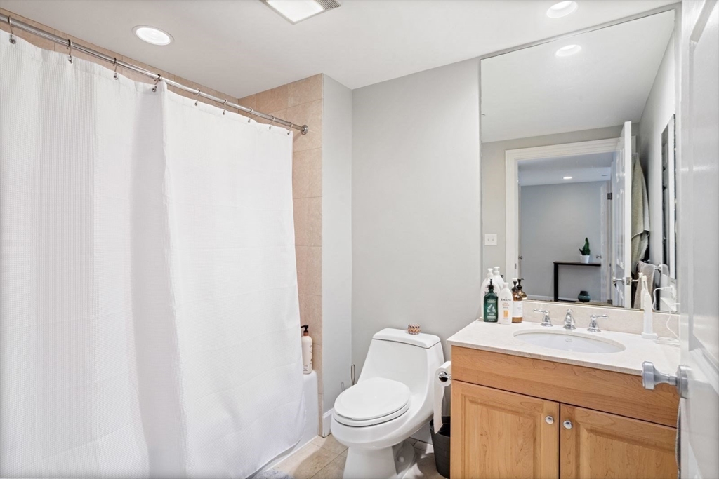 10 Bowdoin Street, Unit 514 Boston, MA 02114 - Photo 10 of 11 a bathroom with a sink a toilet and a mirror