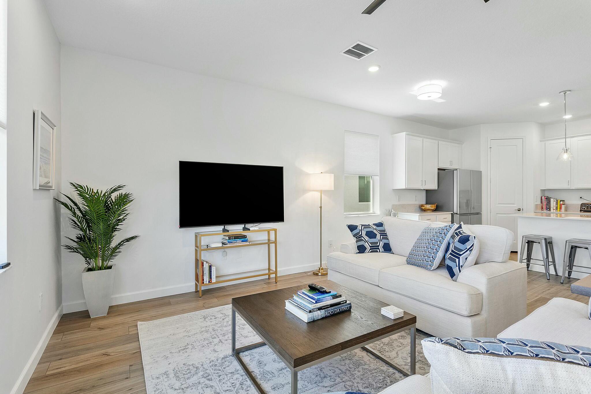 13404 Brotherhood Way Delray Beach, FL 33484 - Photo 11 of 44 a living room with furniture and a flat screen tv