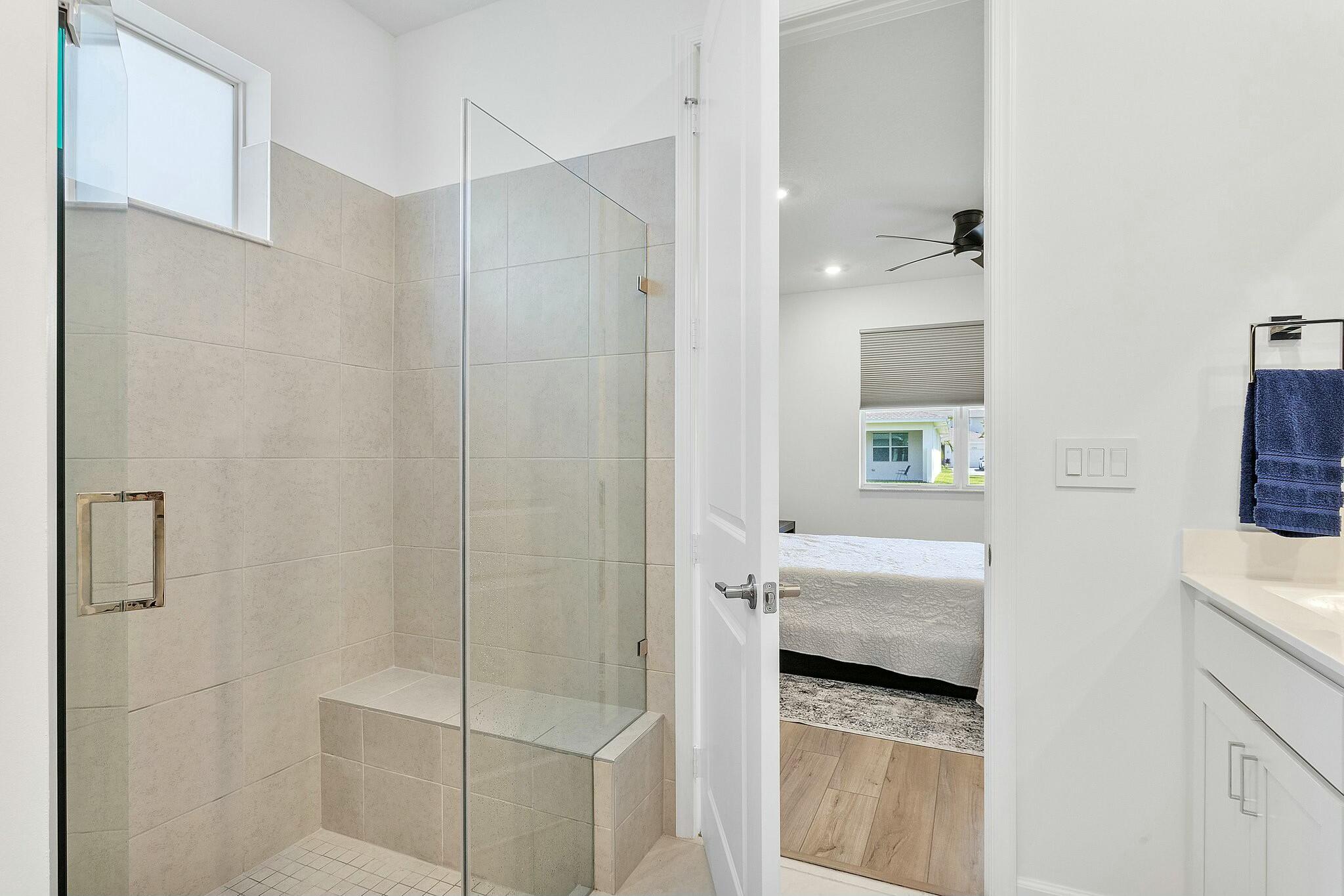 13404 Brotherhood Way Delray Beach, FL 33484 - Photo 17 of 44 a en suite bathroom with a sink a toilet and shower