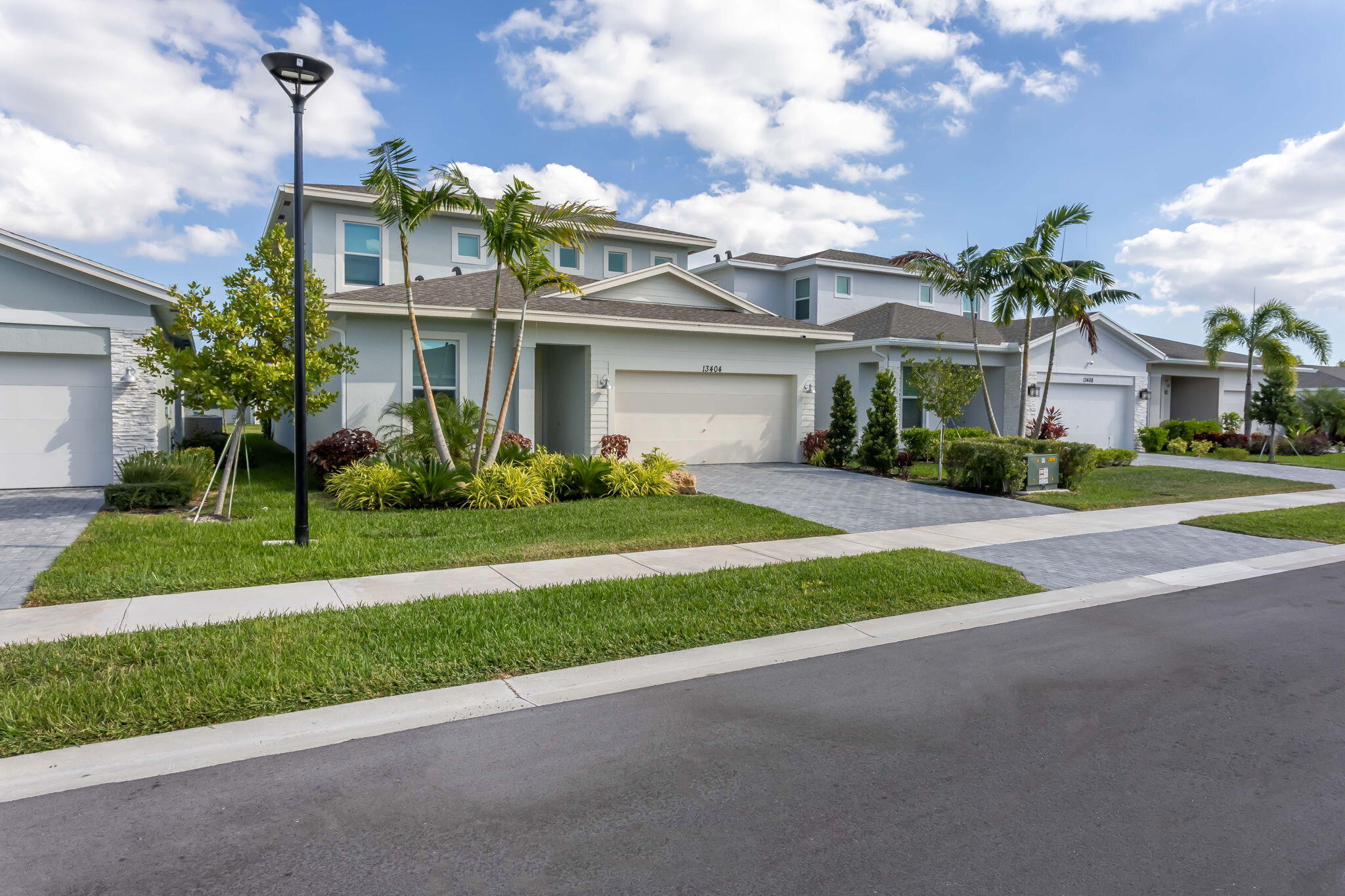 13404 Brotherhood Way Delray Beach, FL 33484 - Photo 2 of 44 a front view of house with yard and green space