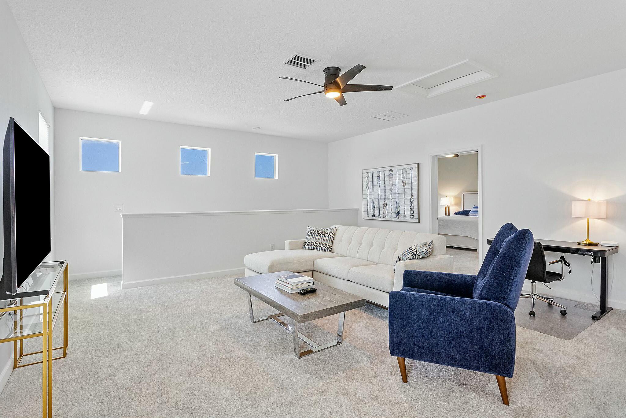 13404 Brotherhood Way Delray Beach, FL 33484 - Photo 26 of 44 a living room with furniture and a flat screen tv