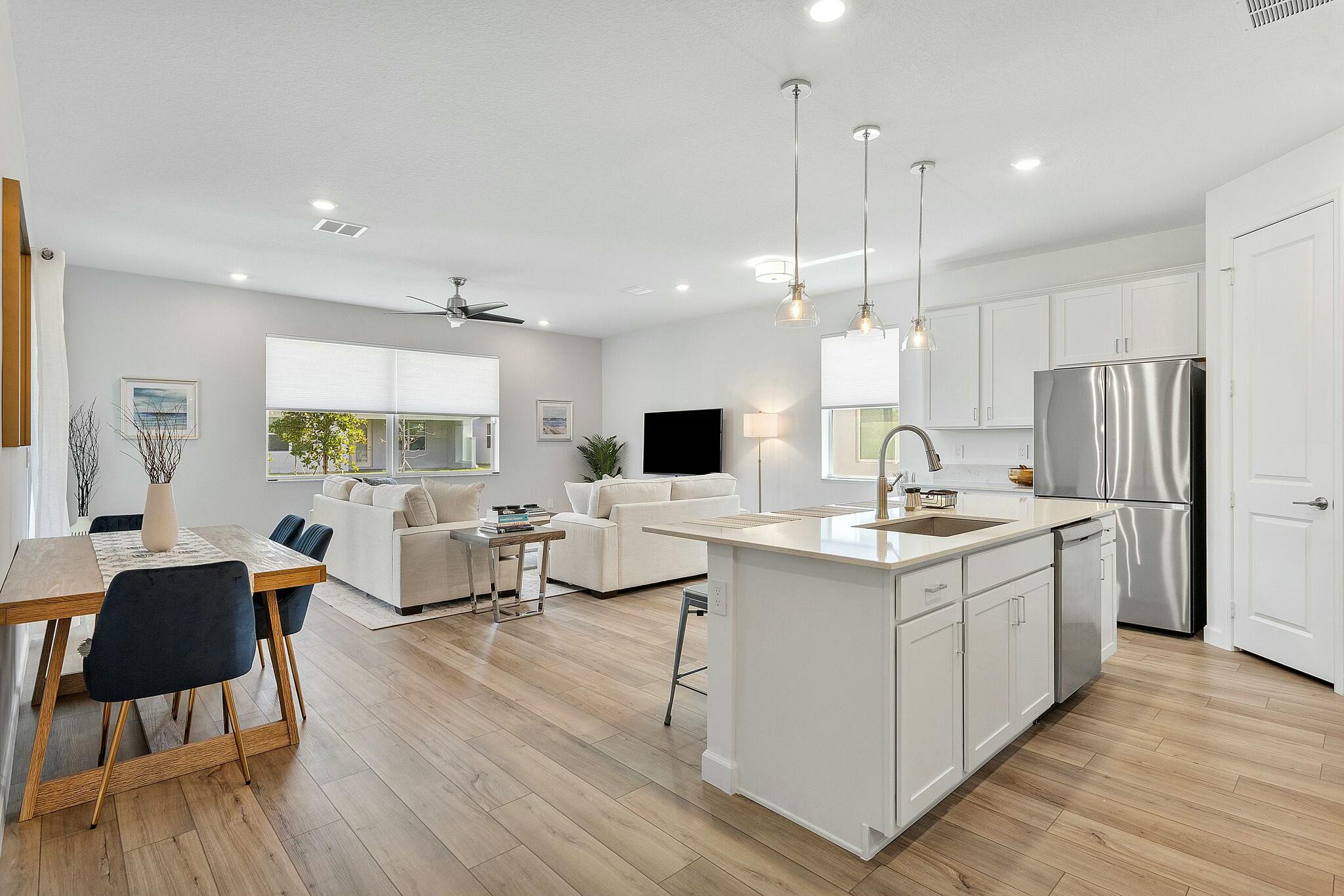 13404 Brotherhood Way Delray Beach, FL 33484 - Photo 4 of 44 a open kitchen with stainless steel appliances kitchen island a white cabinets and couches