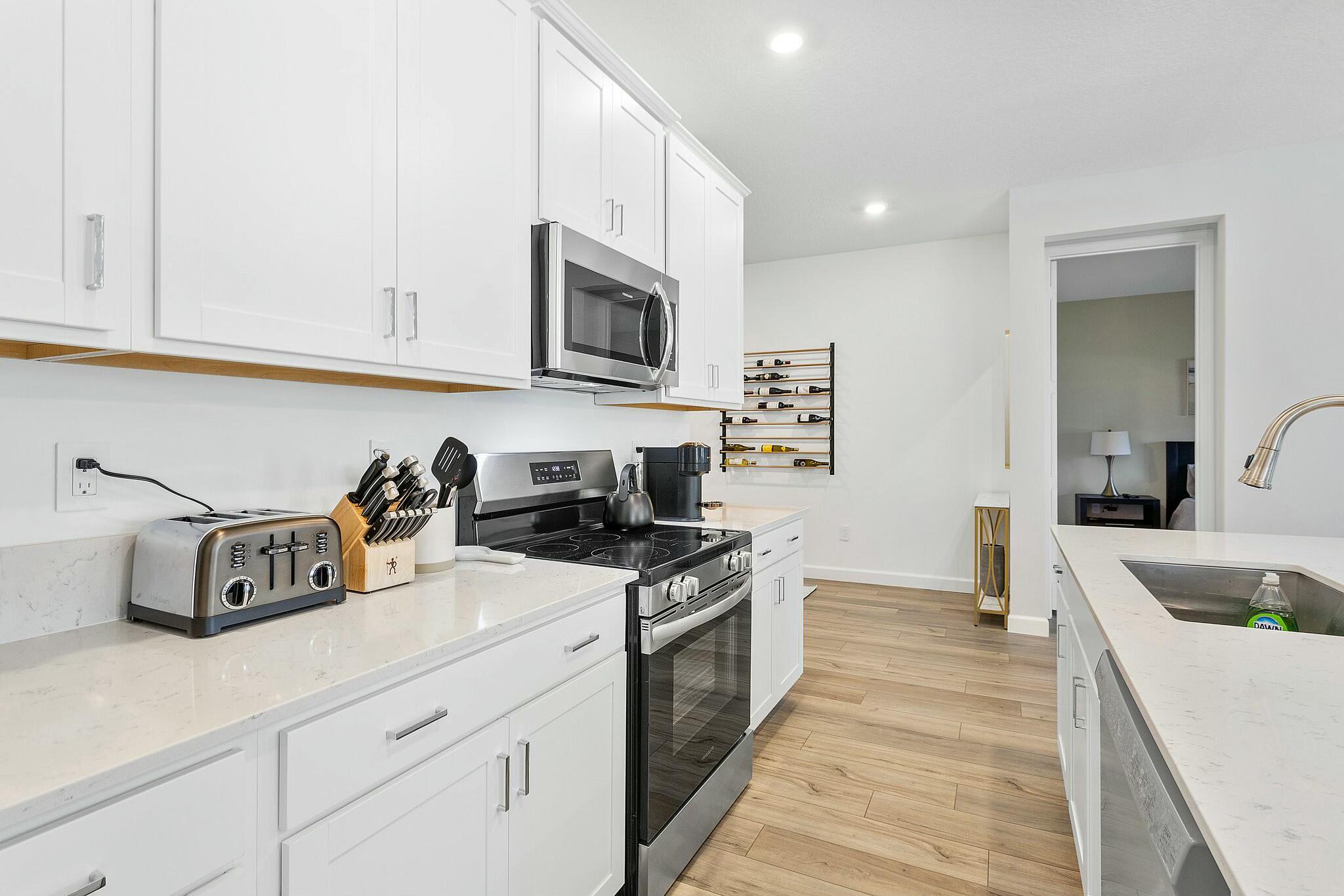 13404 Brotherhood Way Delray Beach, FL 33484 - Photo 5 of 44 a kitchen with stainless steel appliances granite countertop a sink and cabinets