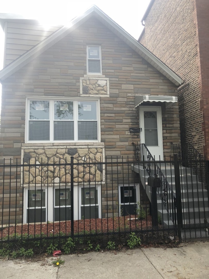 a front view of a house with a street
