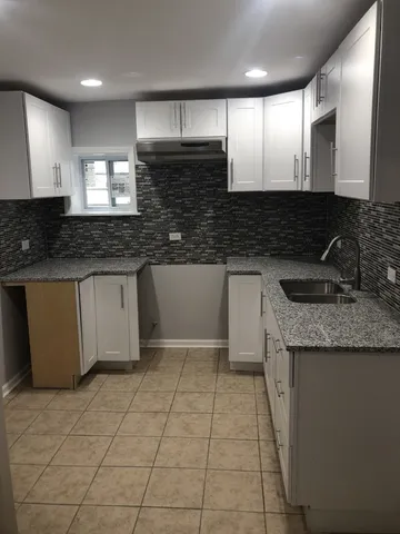 a kitchen with stainless steel appliances granite countertop a sink and a stove