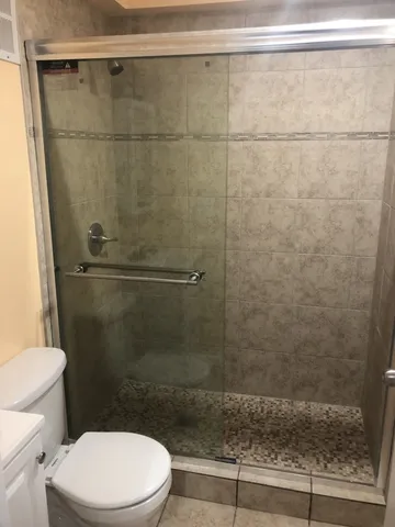 a bathroom with a shower and a toilet