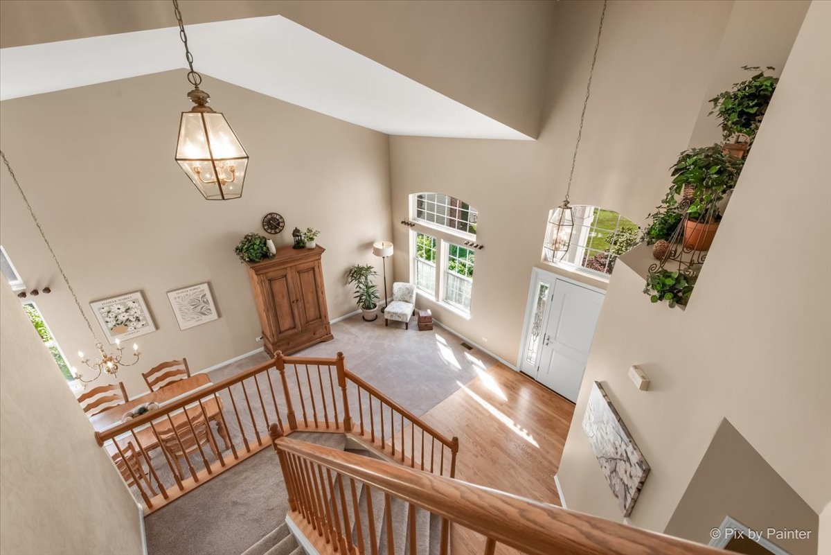 210 Ellis Road Lake In The Hills, IL 60156 - Photo 20 of 57 a view of an entryway wooden floor and chandelier