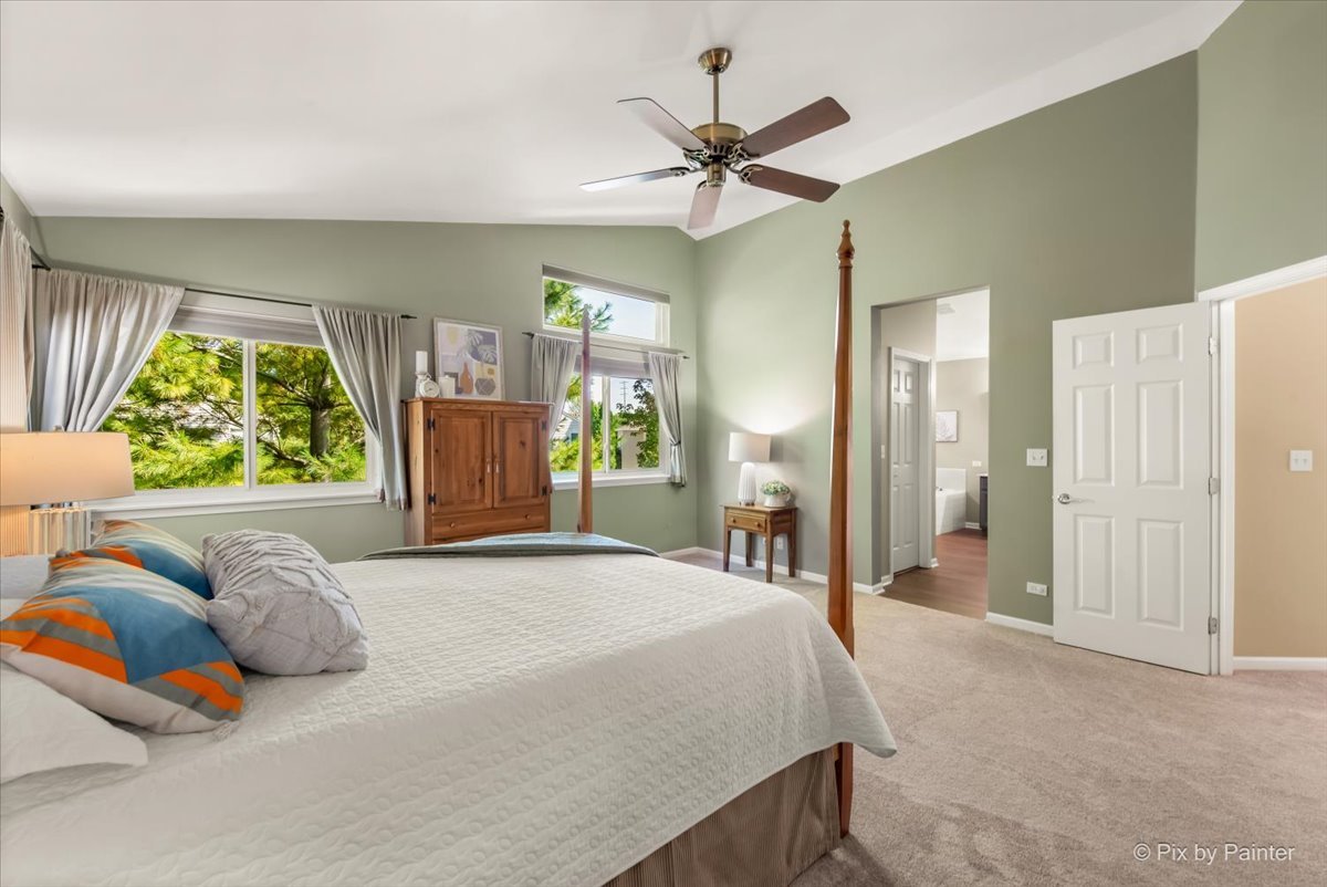 210 Ellis Road Lake In The Hills, IL 60156 - Photo 23 of 57 a bedroom with a bed and a chandelier