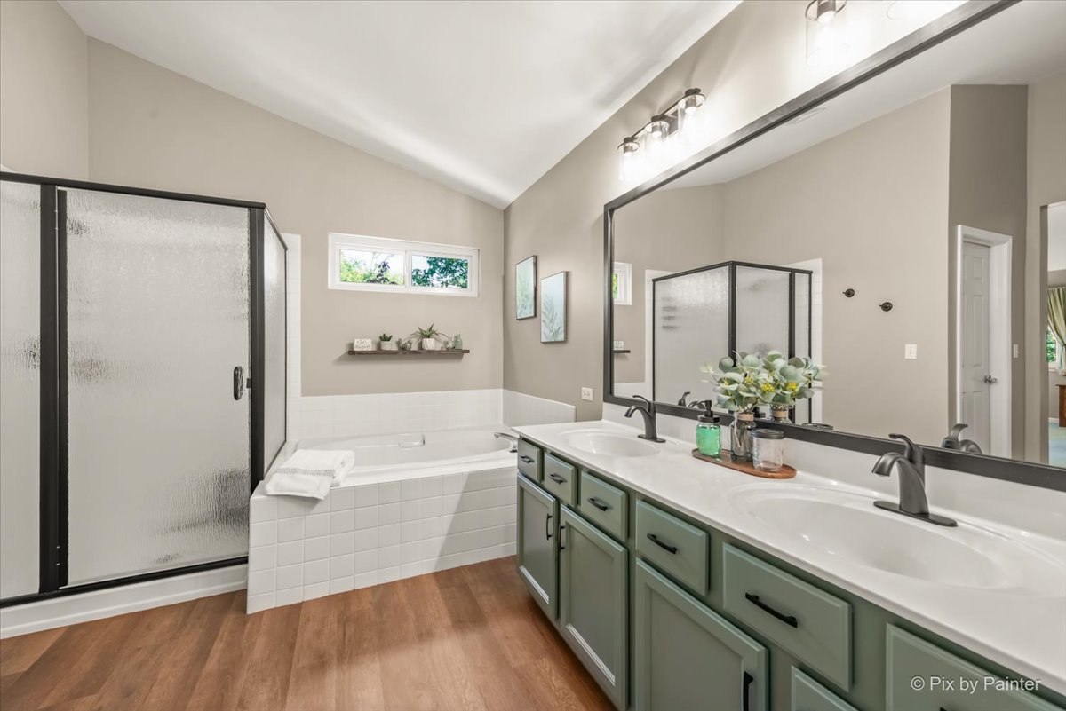 210 Ellis Road Lake In The Hills, IL 60156 - Photo 24 of 57 a spacious bathroom with a double vanity sink a mirror and a bathtub