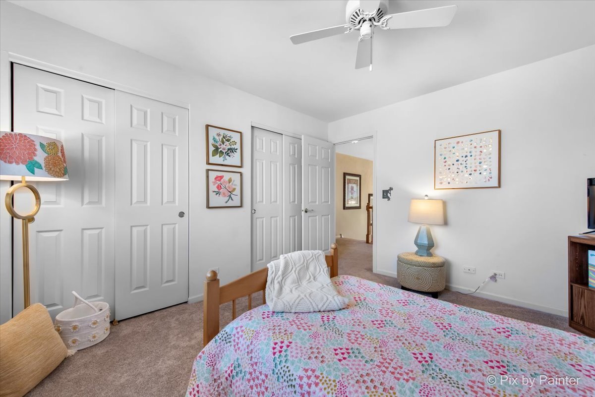 210 Ellis Road Lake In The Hills, IL 60156 - Photo 26 of 57 a bedroom with a bed and a chandelier
