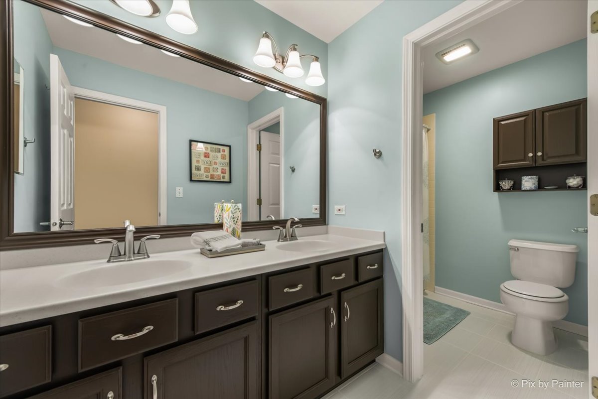 210 Ellis Road Lake In The Hills, IL 60156 - Photo 27 of 57 a bathroom with a double vanity sink and a mirror