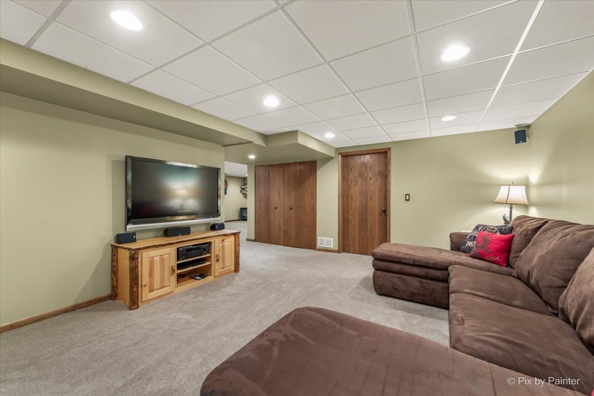 210 Ellis Road Lake In The Hills, IL 60156 - Photo 37 of 57 a living room with furniture and a flat screen tv