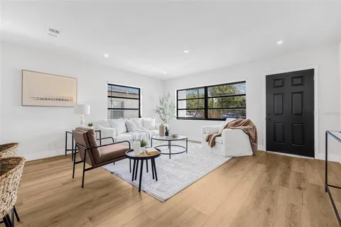 a living room with furniture rug and window