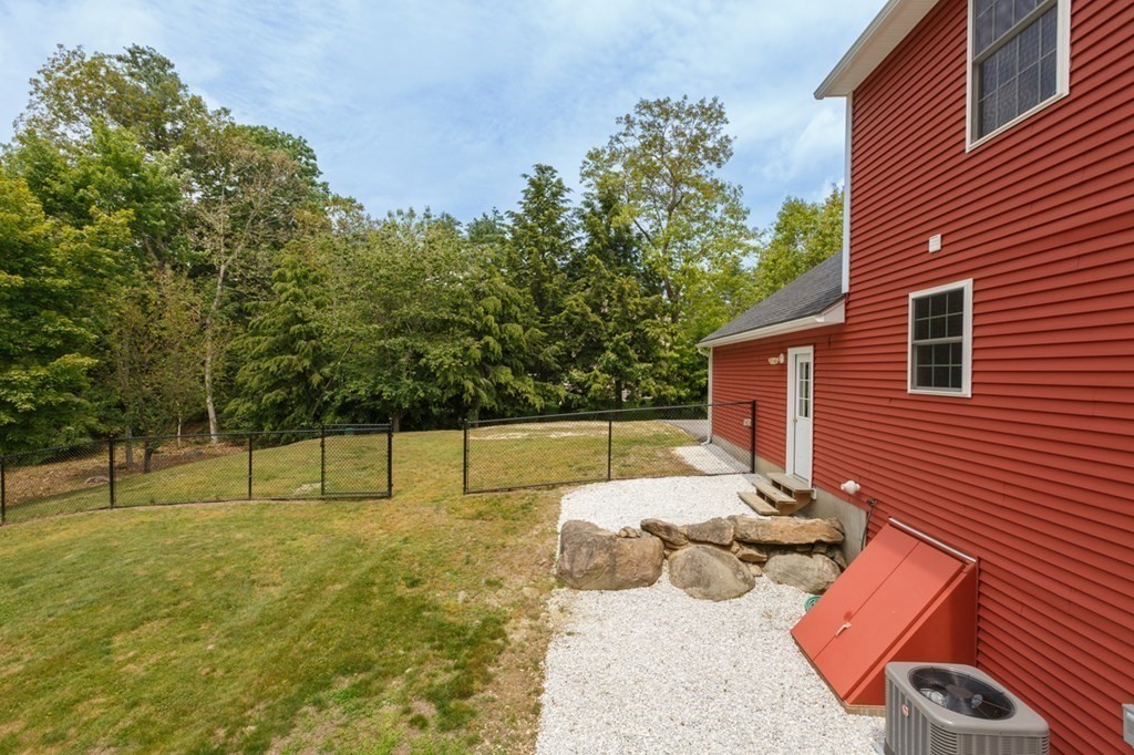 8 Ames Road Brookline, NH 03033 - Photo 24 of 26 a backyard of a house with table and chairs