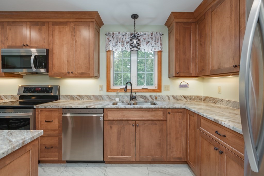 8 Ames Road Brookline, NH 03033 - Photo 3 of 26 a kitchen with stainless steel appliances granite countertop a sink stove and refrigerator