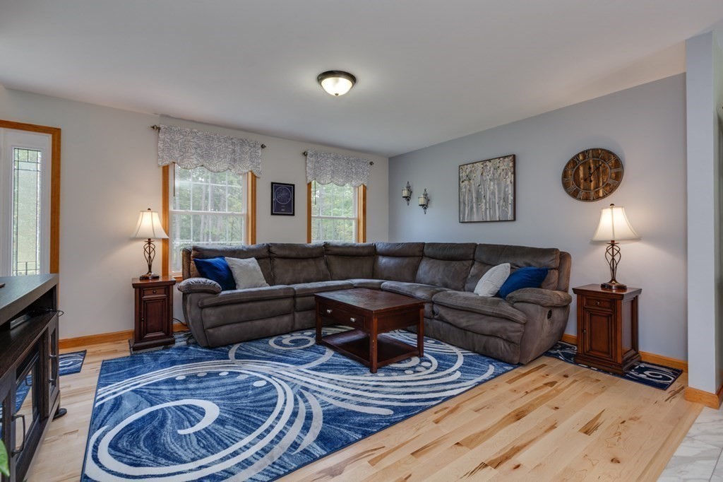 8 Ames Road Brookline, NH 03033 - Photo 5 of 26 a living room with furniture a rug and wall painting