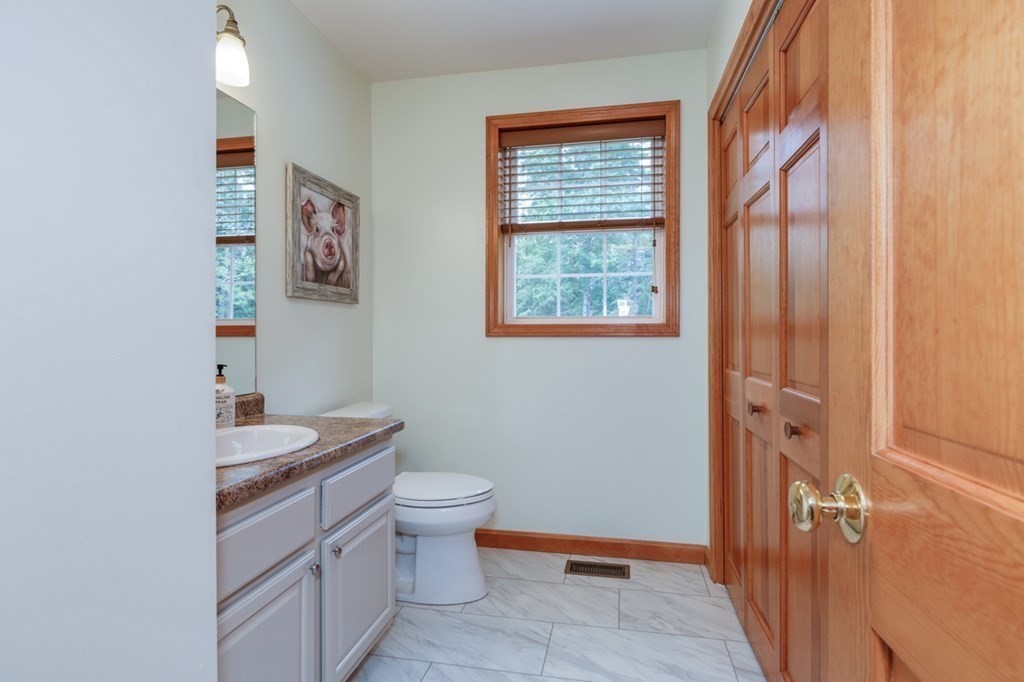 8 Ames Road Brookline, NH 03033 - Photo 6 of 26 a bathroom with a granite countertop toilet sink and mirror