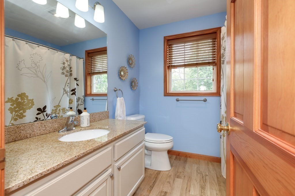 8 Ames Road Brookline, NH 03033 - Photo 10 of 26 a bathroom with a granite countertop sink toilet and a mirror