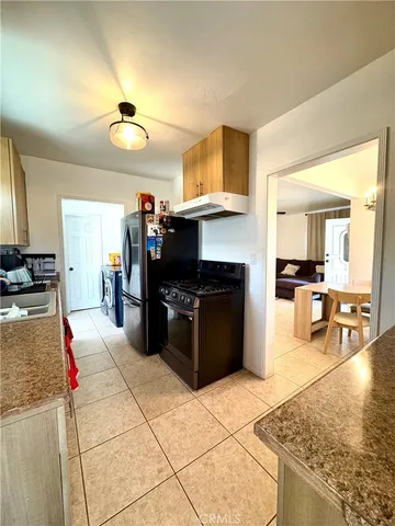 a kitchen with a stove kitchen island and couches