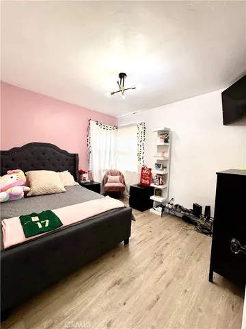 a bedroom with a bed and a tv