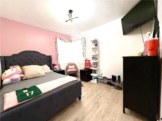 a bedroom with a bed window and couch