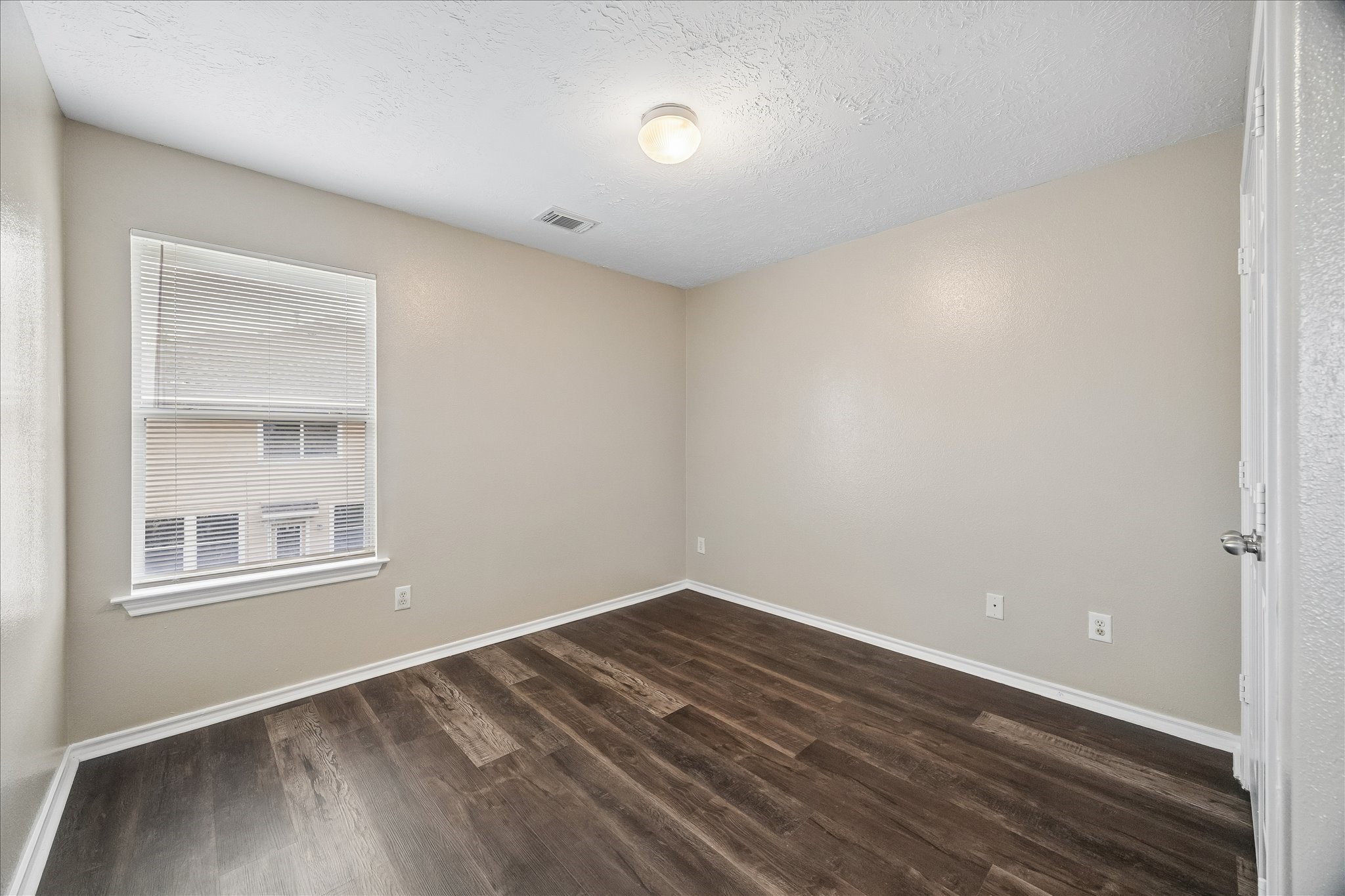 14334 Fairbuff Lane Houston, TX 77014 - Photo 12 of 15 a view of an empty room with wooden floor and a window