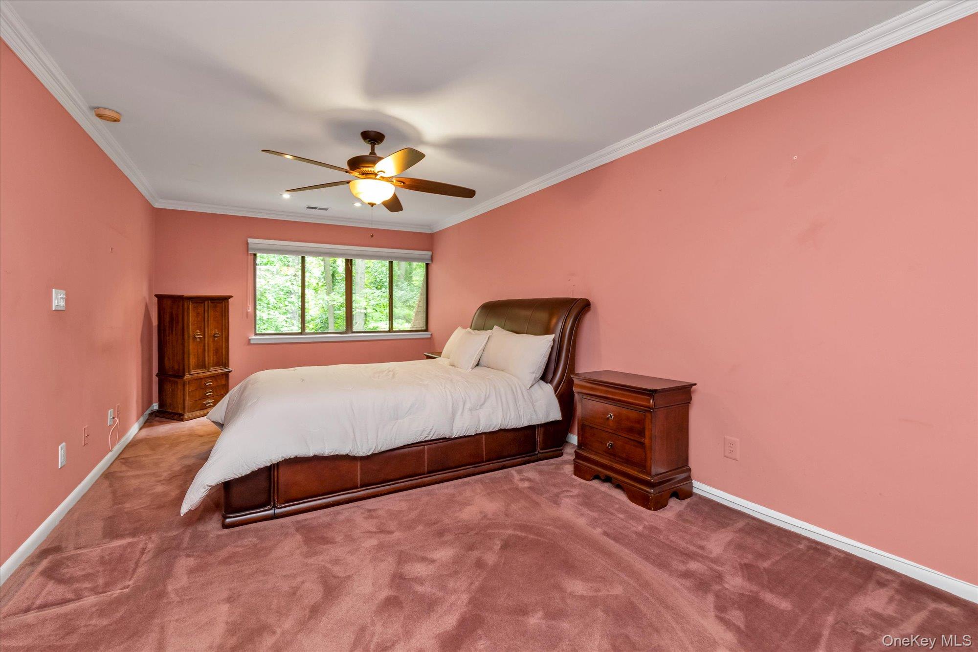 41 Spring Hollow Road Roslyn, NY 11576 - Photo 12 of 27 a spacious bedroom with a bed and a ceiling fan