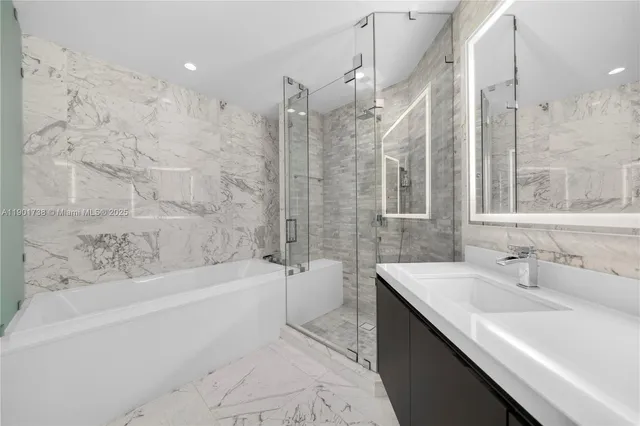 a spacious bathroom with a bathtub sink shower and a mirror