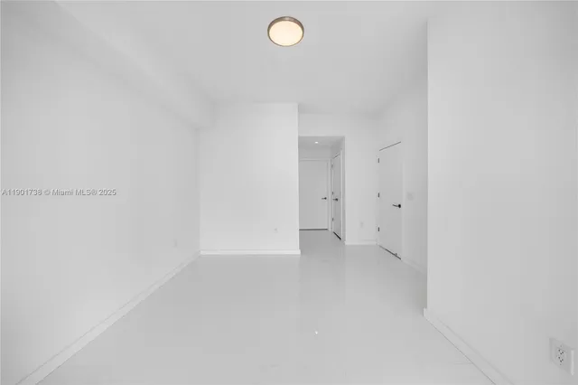 a view of a kitchen from the hallway with living room