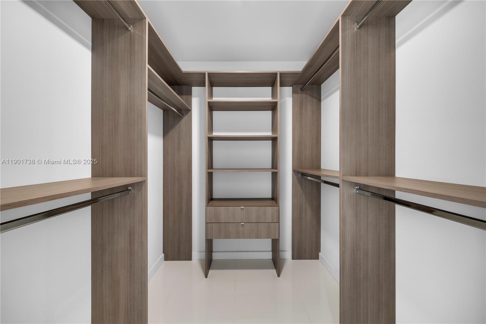 851 Northeast 1st Avenue, Unit 2106 Miami, FL 33132 - Photo 16 of 52 a view of walk in closet with empty racks