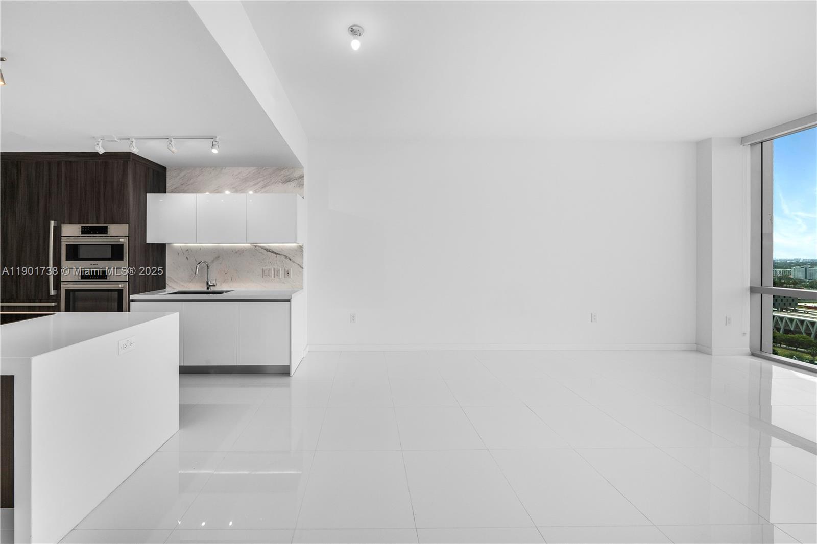 851 Northeast 1st Avenue, Unit 2106 Miami, FL 33132 - Photo 20 of 52 a kitchen with stainless steel appliances a sink and a stove