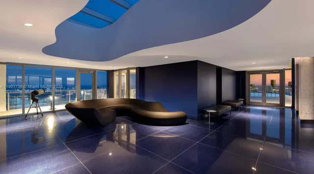 a living room with a table and chairs